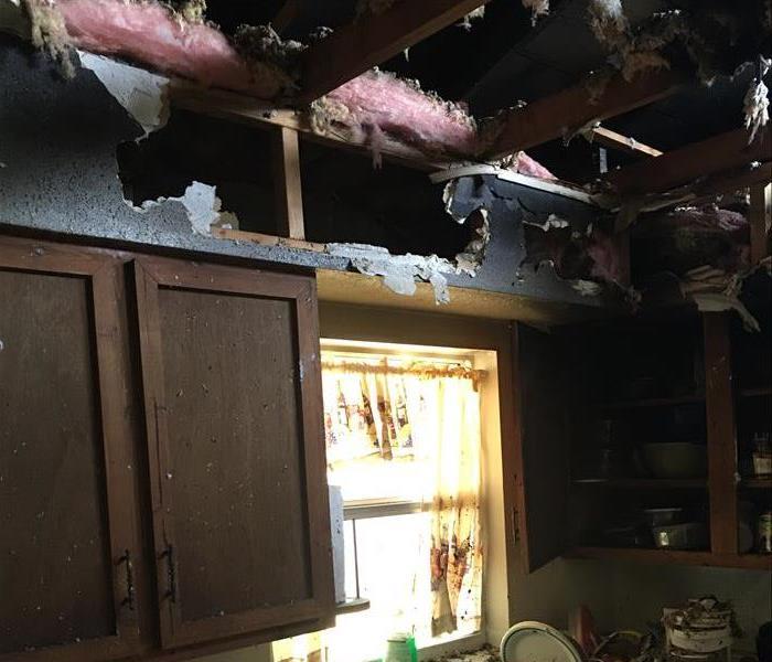 visibly burned ceiling and debris on sink counter area