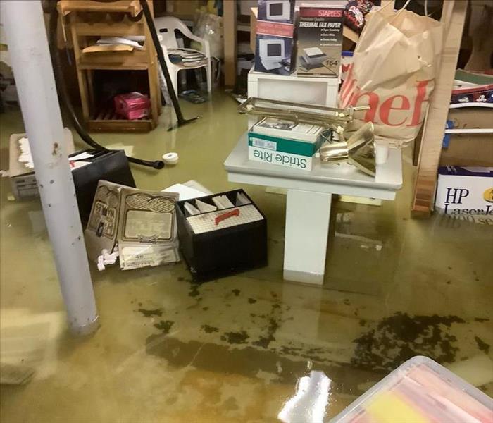 Basement with standing water and household contents