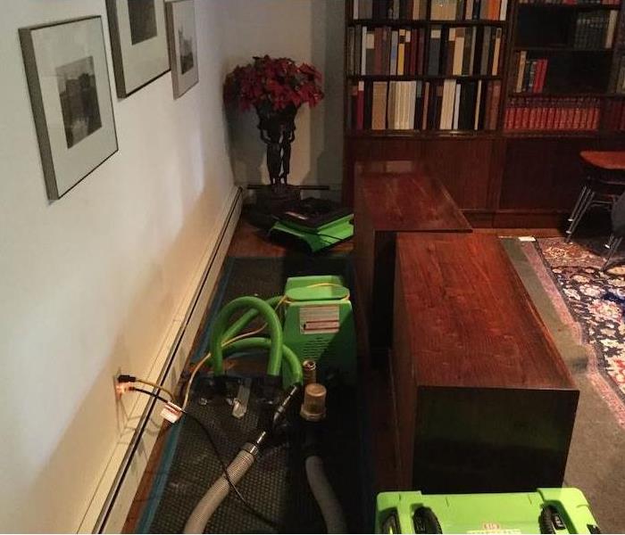 Dining Room with SERVPRO drying equipment on hardwood floor