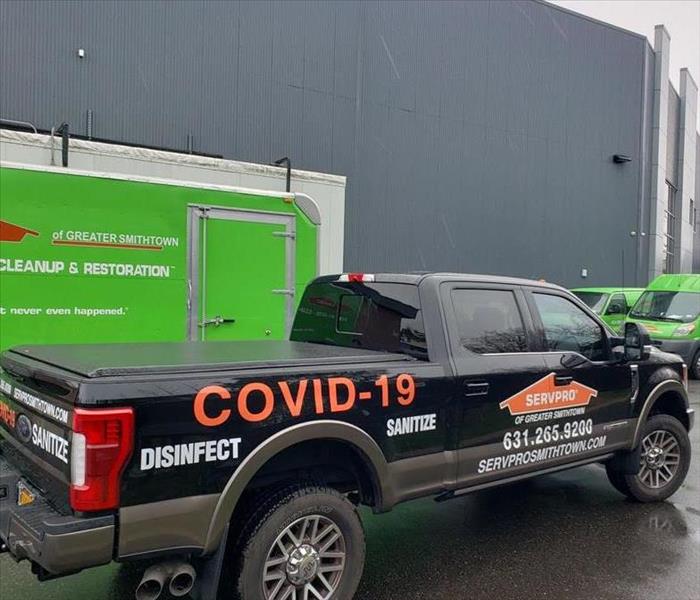 A SERVPRO truck in front of a building. 