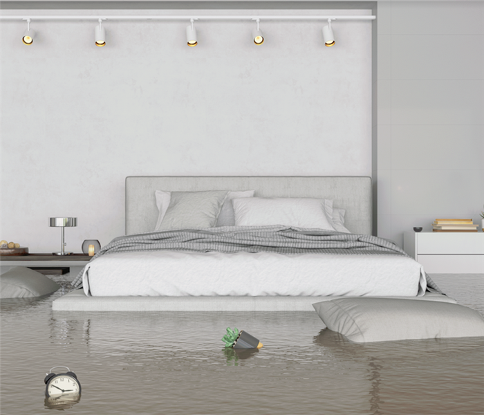 a flooded bedroom with water up to the bed