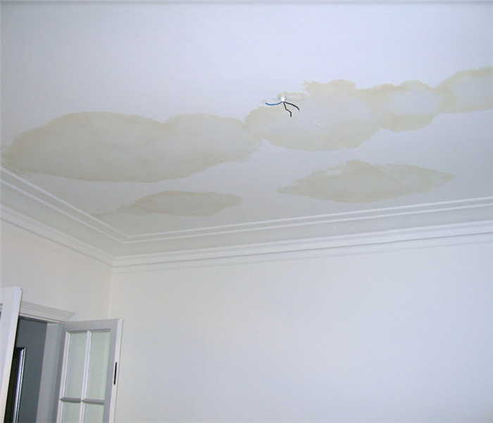 a water damaged ceiling with watermarks all over it